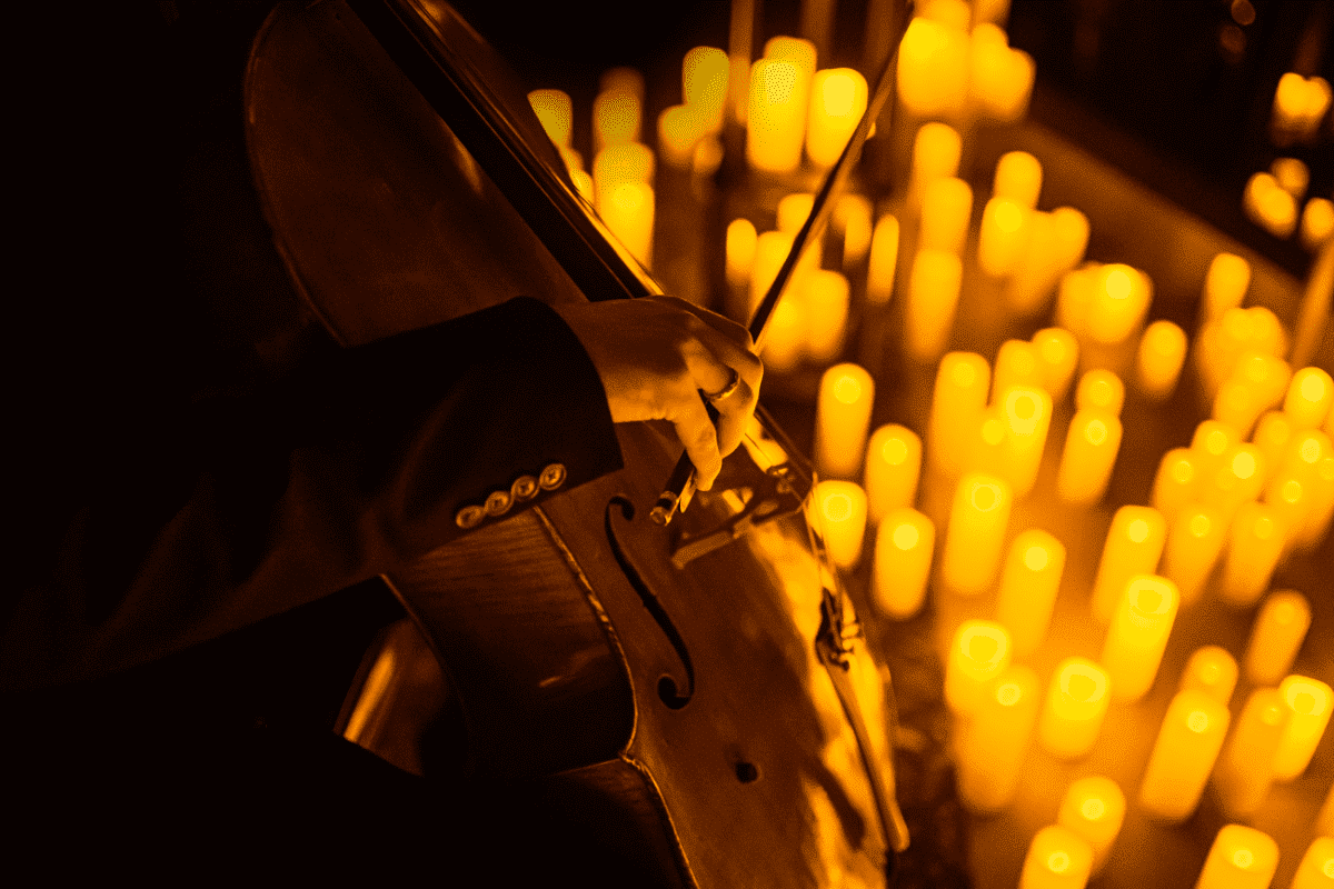 A cello player performs by candlelight