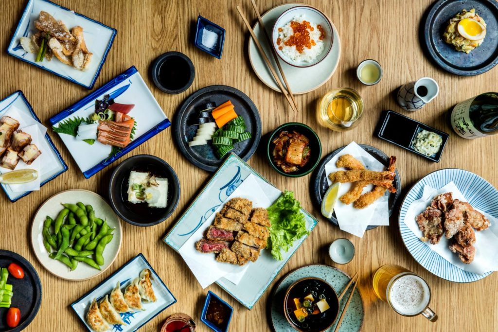 A table filled with Japanese dishes at Jah Izakaya & Sake Bar. 