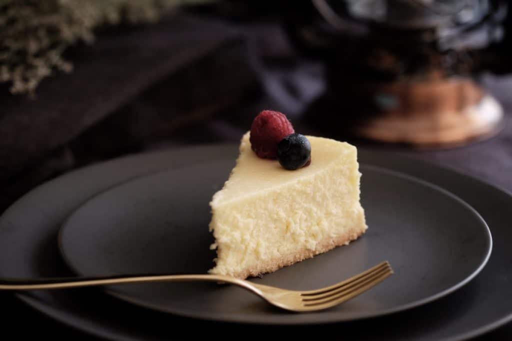 A slice of cheesecake topped with berries.